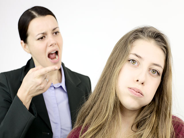 Girl looking desperate about angry mother